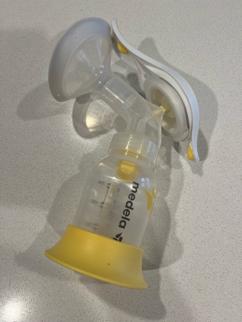 Medela Handheld Breast Pump in Clear and Yellow